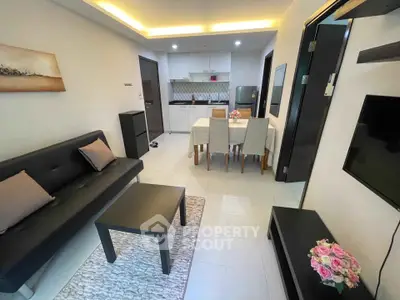 Modern open-plan living room and kitchen with stylish decor and cozy ambiance.