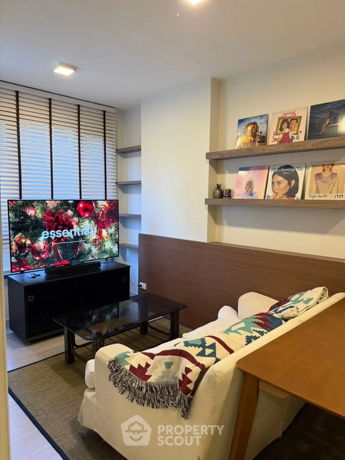 Cozy living room with modern decor and entertainment setup, perfect for relaxation.