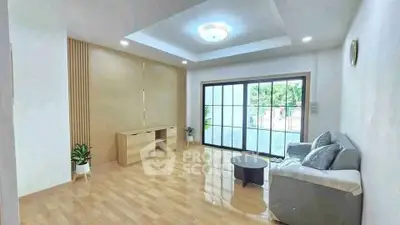 Spacious living room with modern decor and large windows offering natural light.