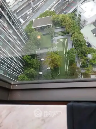 Stunning aerial view of modern urban garden from high-rise building window.