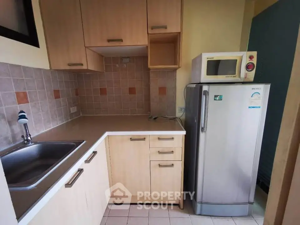 Compact kitchen with modern appliances and ample storage space