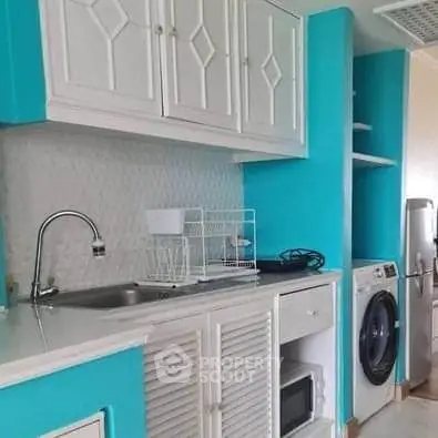 Charming kitchen with vibrant blue cabinets and modern appliances