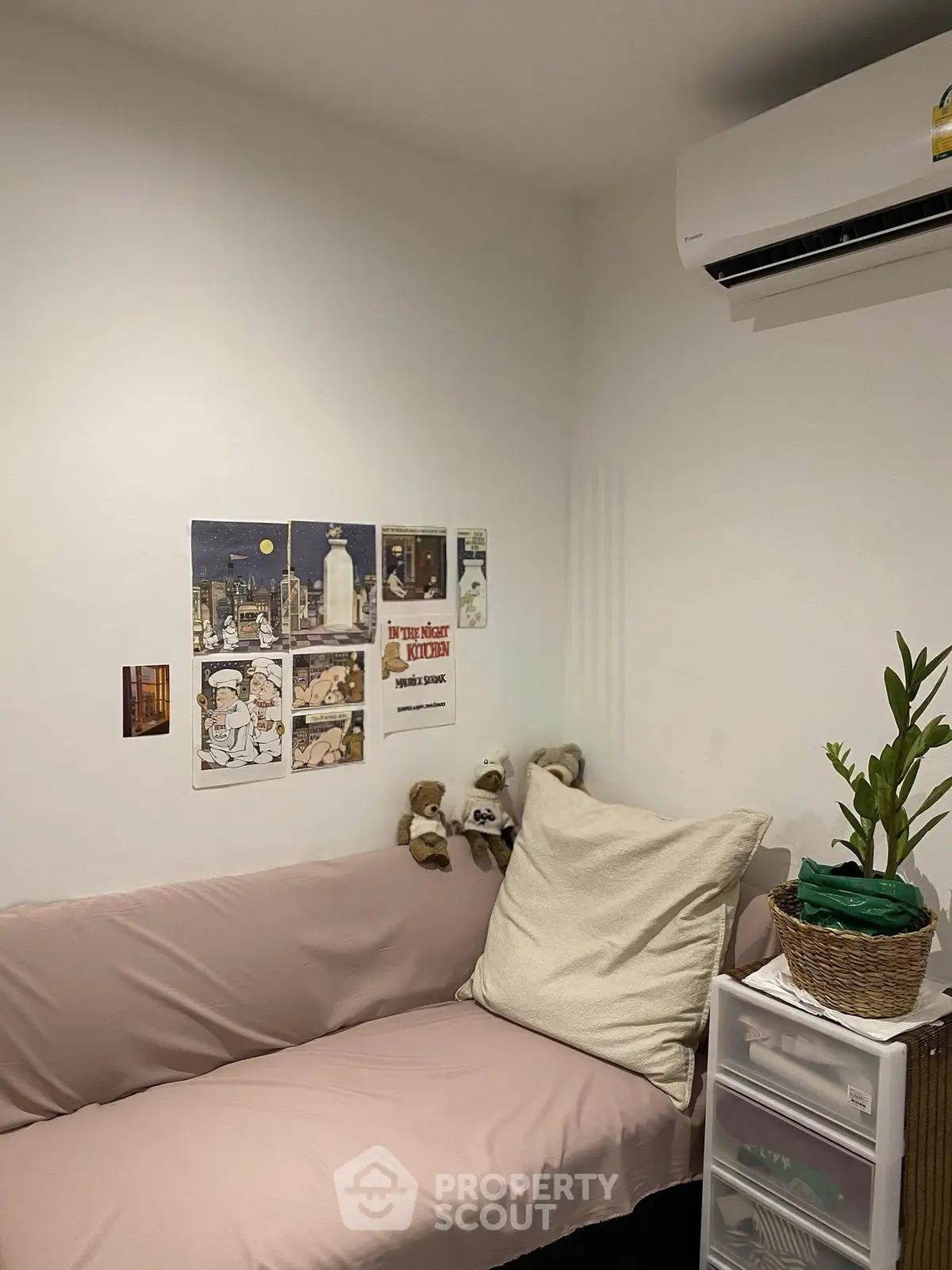 Cozy small living space with air conditioning and wall decor, perfect for compact urban living.