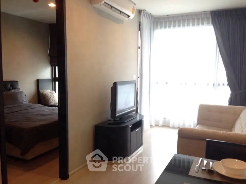 Modern apartment interior with cozy living room and bedroom, featuring large windows and stylish furniture.