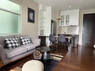 Modern living room with stylish kitchen, cozy sofa, and elegant decor in open layout apartment.