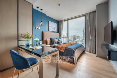 Luxurious bedroom with city view, modern decor, and elegant furnishings in high-rise apartment.
