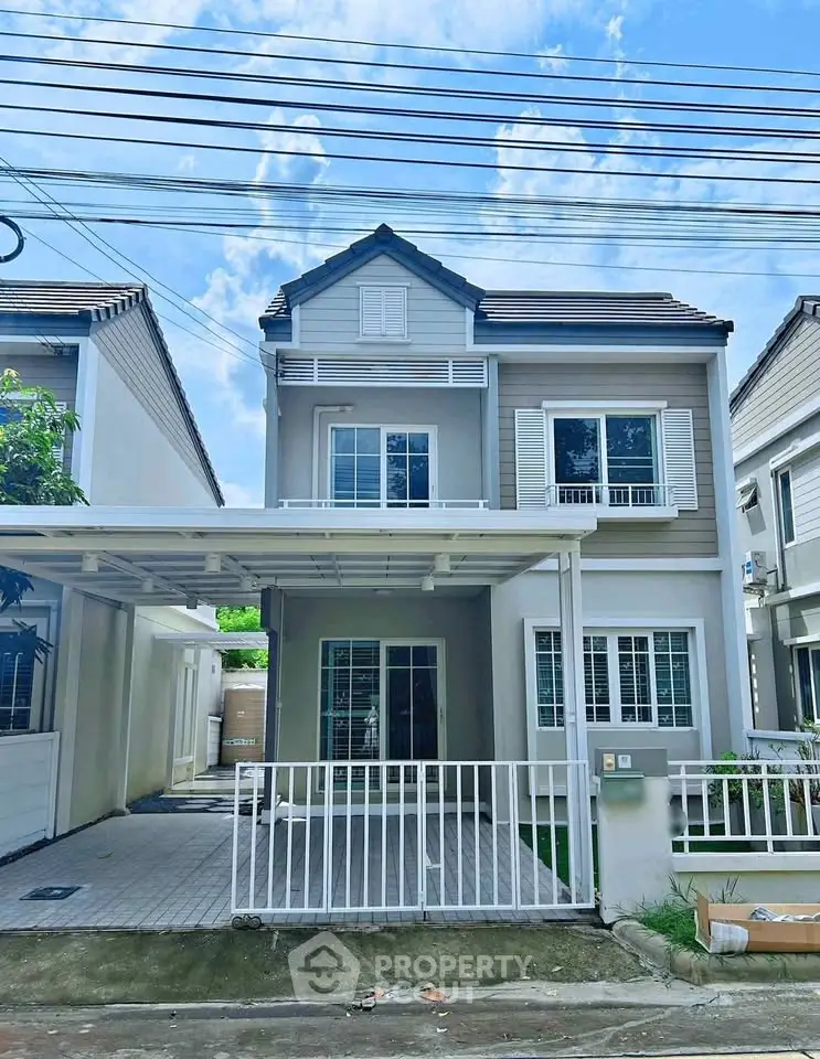 Charming two-story house with modern facade and spacious driveway in a serene neighborhood.