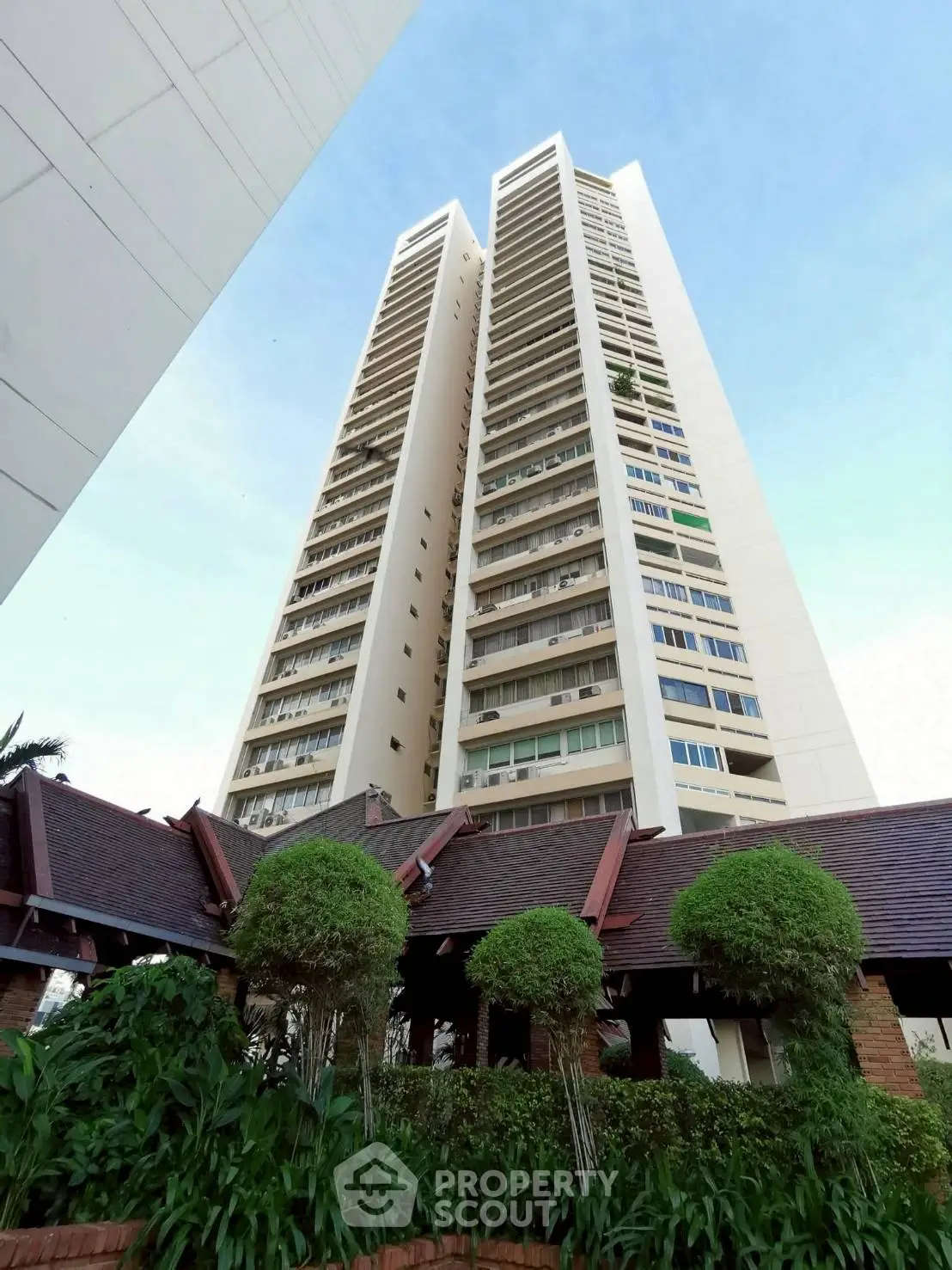 Stunning high-rise building with lush greenery and modern architecture