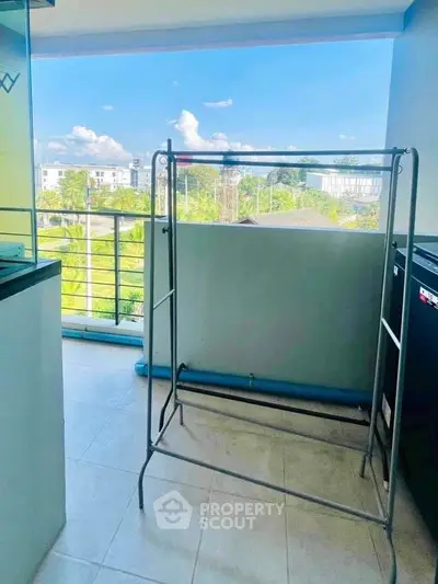 Spacious balcony with scenic view and ample sunlight, perfect for relaxation and outdoor activities.