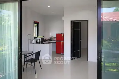 Modern kitchen with red fridge and dining area in open layout design