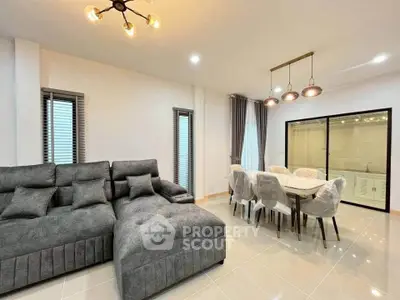 Modern living room with stylish gray sectional sofa and elegant dining area