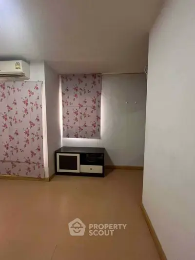 Cozy room with floral curtains and air conditioning, perfect for a serene living space.