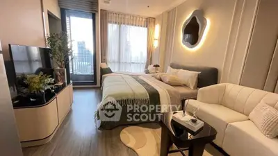 Modern bedroom with stylish decor, cozy seating, and city view balcony access.