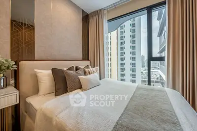 Luxurious bedroom with modern decor and stunning city view from large window.