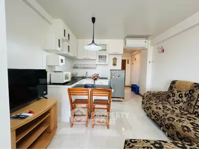 Charming open-layout kitchen and living area with modern appliances and cozy seating.
