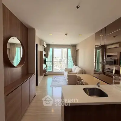 Modern open-plan living room with kitchen and city view balcony