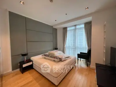 Spacious modern bedroom with large window and stylish decor