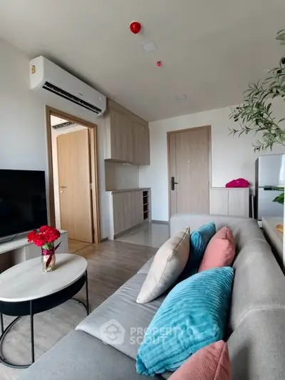Modern living room with stylish decor and air conditioning in a cozy apartment.