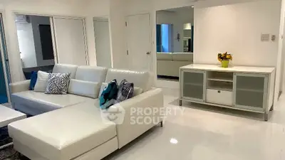Modern living room with white leather sectional sofa and sleek decor
