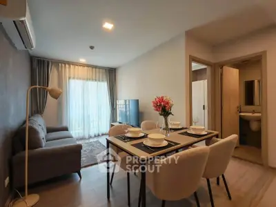 Modern living room with dining area and stylish decor in a cozy apartment.