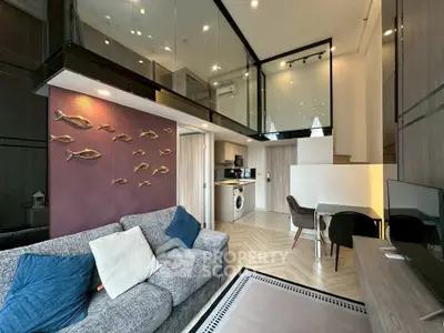 Modern loft apartment with stylish decor and open layout, featuring a cozy living area and compact kitchen.