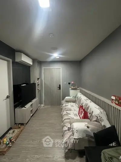 Cozy living room with modern decor and comfortable seating in a stylish apartment.