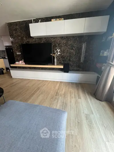 Modern living room with sleek TV unit and elegant wood flooring