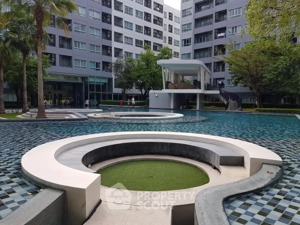 Modern apartment complex with stylish pool and lush greenery