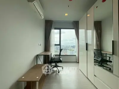 Modern study room with city view, sleek furniture, and ample natural light.