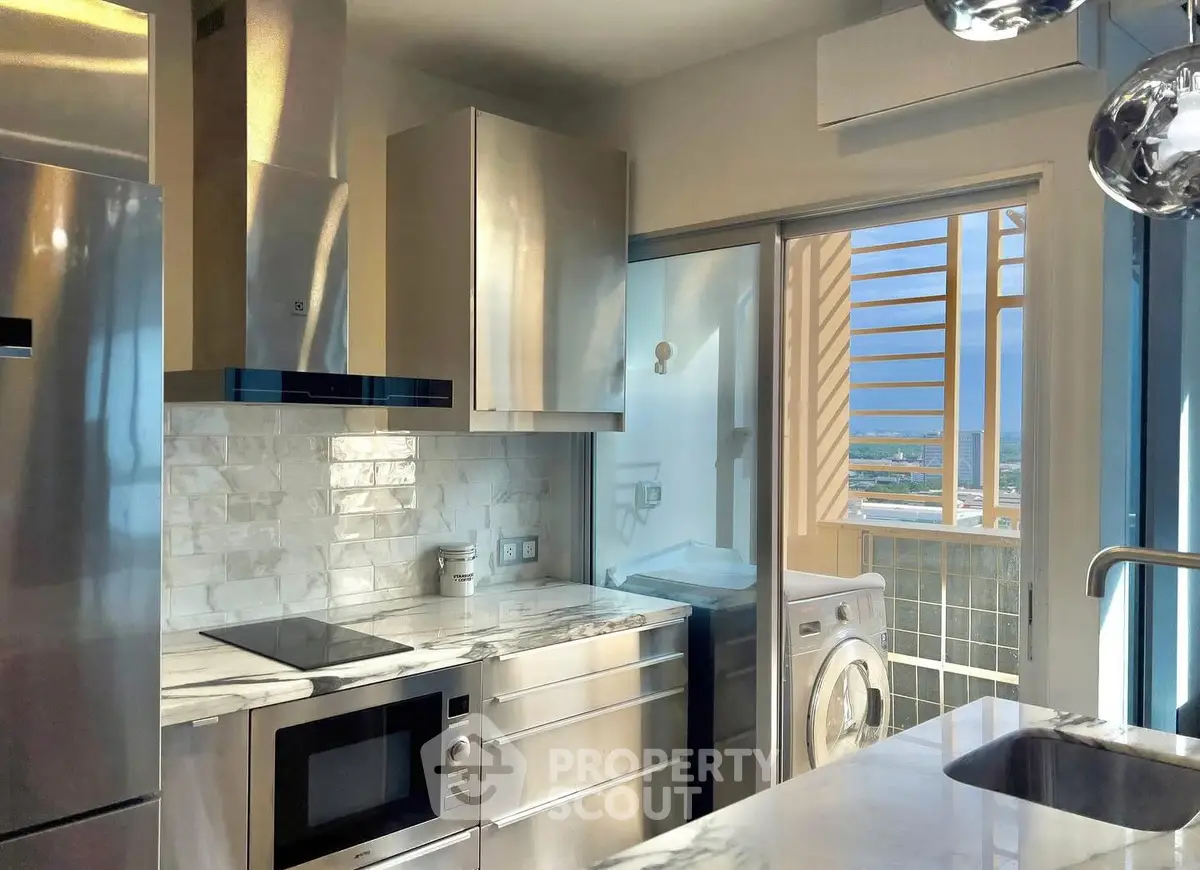 Modern kitchen with sleek appliances and stunning view from balcony