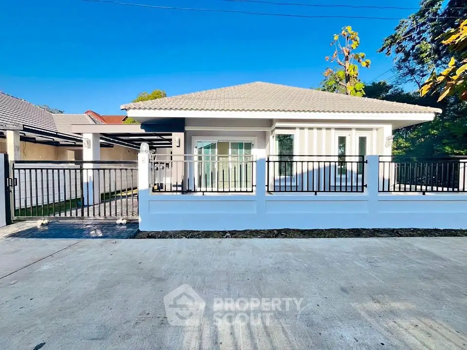 Charming single-story house with modern design and spacious driveway in a serene neighborhood.