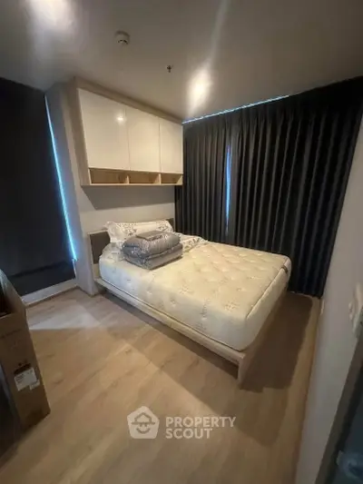 Cozy bedroom with modern design, featuring a comfortable bed and stylish storage solutions.