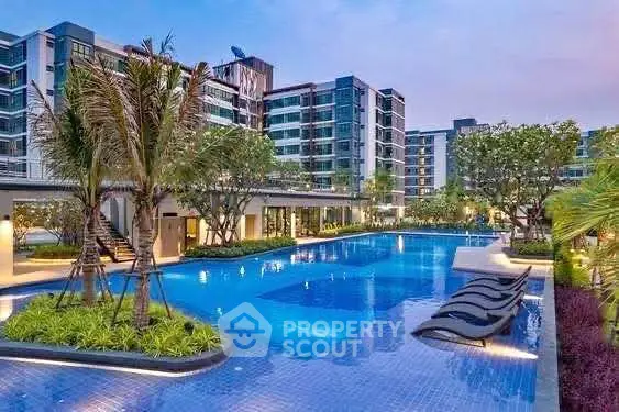 Luxurious modern apartment complex with stunning pool and lush landscaping.