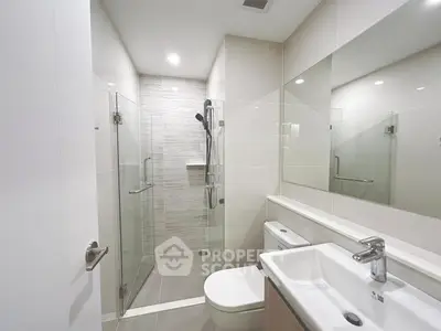 Modern bathroom with glass shower and sleek fixtures
