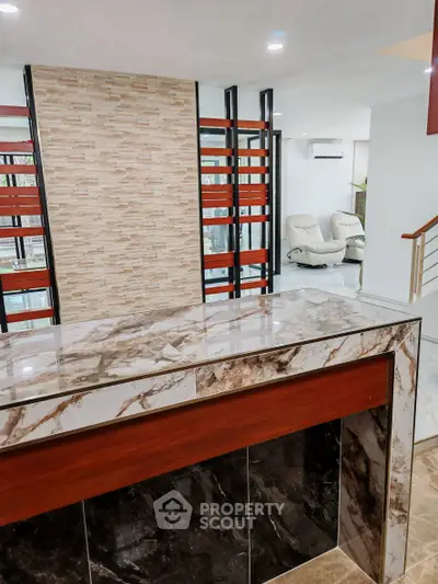 Modern interior with marble accents and stylish partition in a luxurious living space.