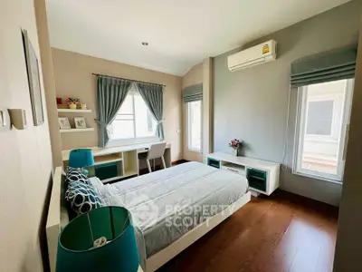 Modern bedroom with stylish decor and ample natural light