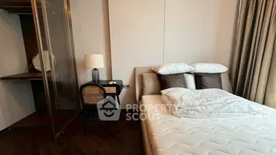 Modern bedroom with stylish decor and cozy ambiance, featuring a comfortable bed and elegant furnishings.