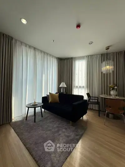 Modern living room with elegant decor and natural light in a stylish apartment.