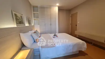 Modern bedroom with cozy bed and stylish decor in a contemporary apartment.