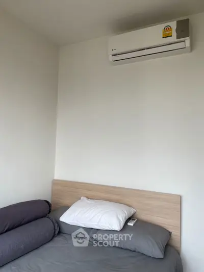 Cozy bedroom with modern air conditioning and comfortable bedding