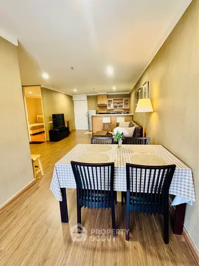 Spacious open-plan living and dining area with modern kitchen in a stylish apartment.
