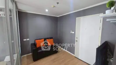 Modern living room with sleek design and cozy seating in a stylish apartment.