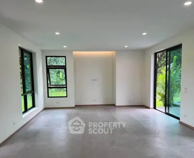 Spacious modern living room with large windows and garden view