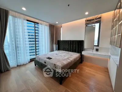 Luxurious bedroom with modern design and city view, featuring elegant furnishings and ample natural light.