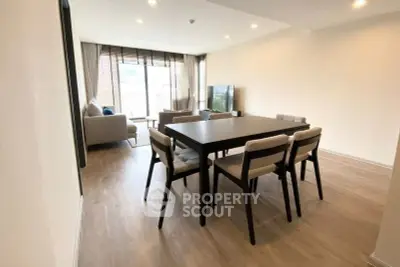 Spacious modern living room with dining area and large windows for natural light.
