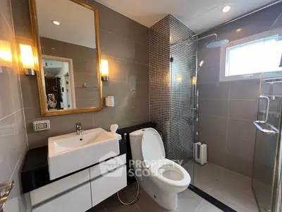 Modern bathroom with sleek fixtures and glass shower enclosure