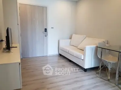 Modern living room with cozy sofa and sleek TV setup in stylish apartment.