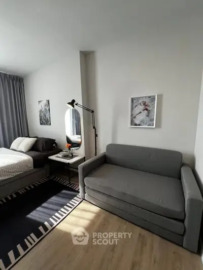 Modern bedroom with stylish decor and cozy seating area, perfect for relaxation.