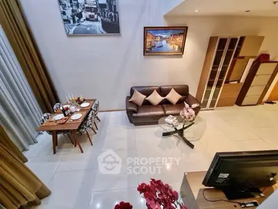 Spacious living room with elegant decor and dining area in modern apartment.