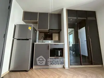 Modern compact kitchen with sleek cabinets and appliances in a stylish apartment